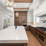 Modern kitchen remodeling with marble countertops stainless steel appliances and hardwood floors serving Austin Round Rock…