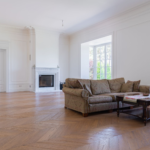Spacious living room with elegant furniture and hardwood flooring installation by BH Remodeling serving Austin and Round…