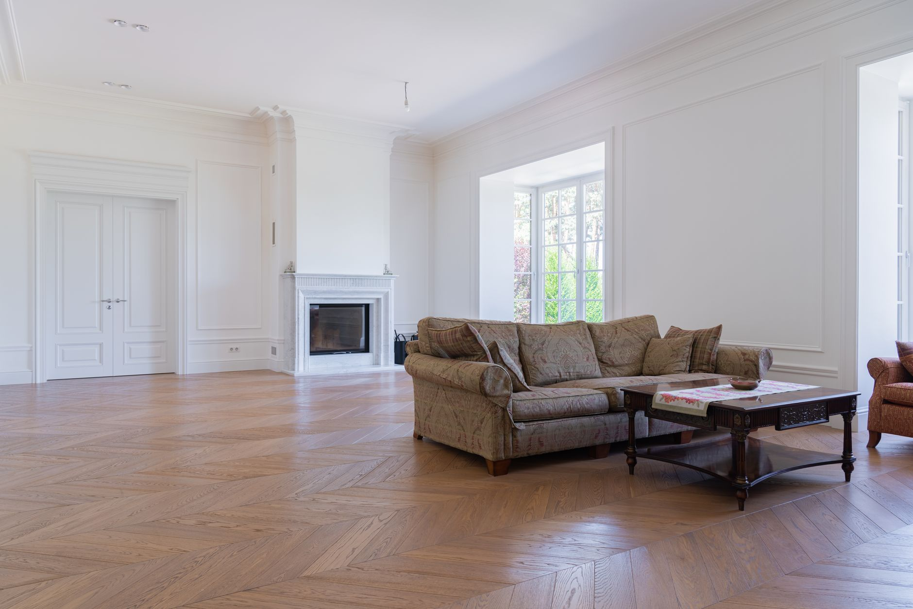 Spacious living room with elegant furniture and hardwood flooring installation by BH Remodeling serving Austin and Round…