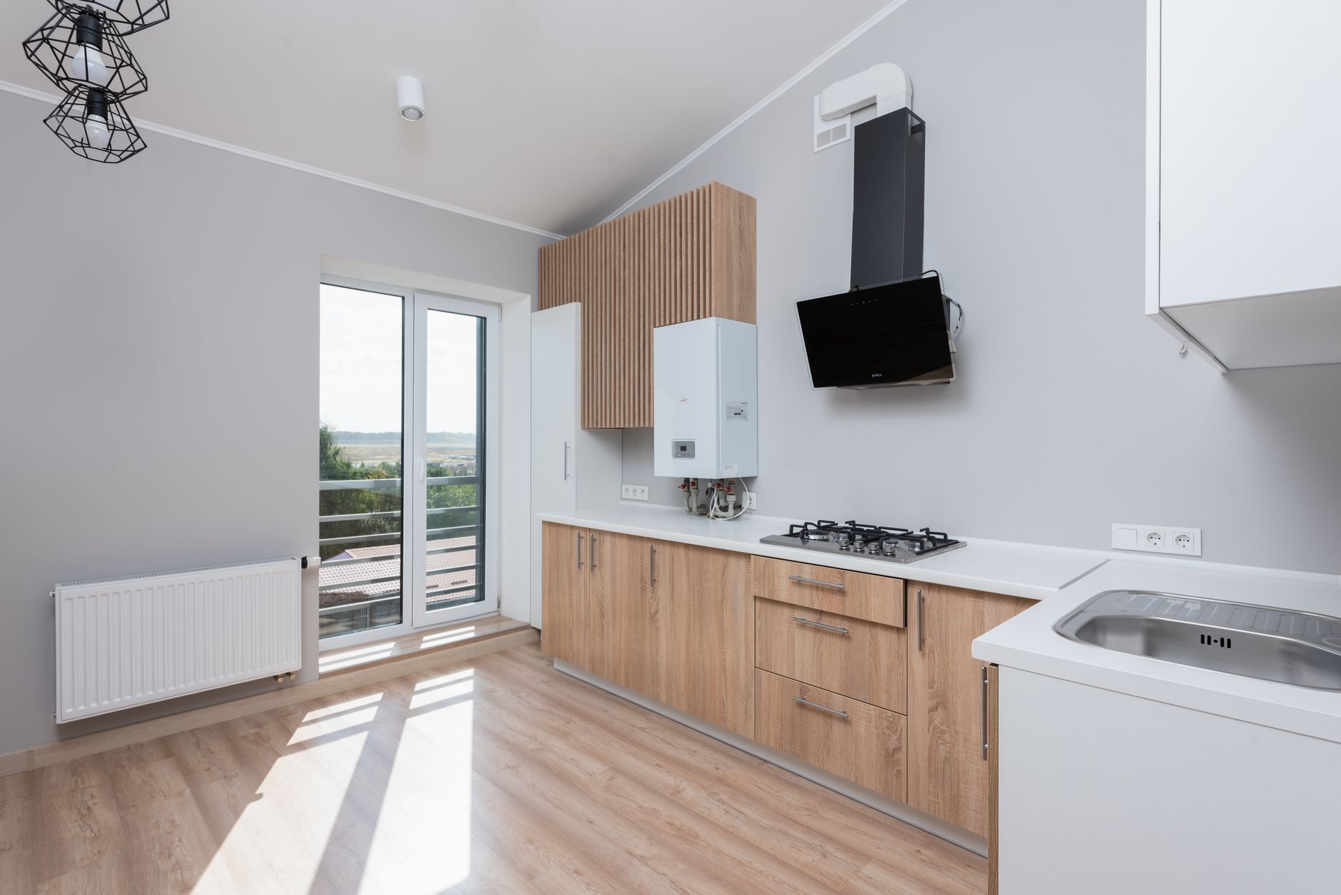 Stylish kitchen with wooden cabinet installation in Austin Round Rock Cedar Park featuring large windows and open layout